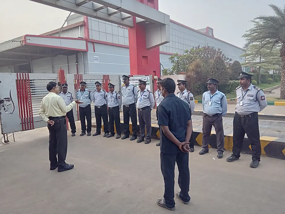 Falcon Eye security supervisor briefing guards at an industrial plant gate